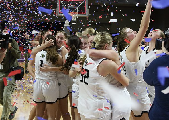 basketball team celebrates win on court